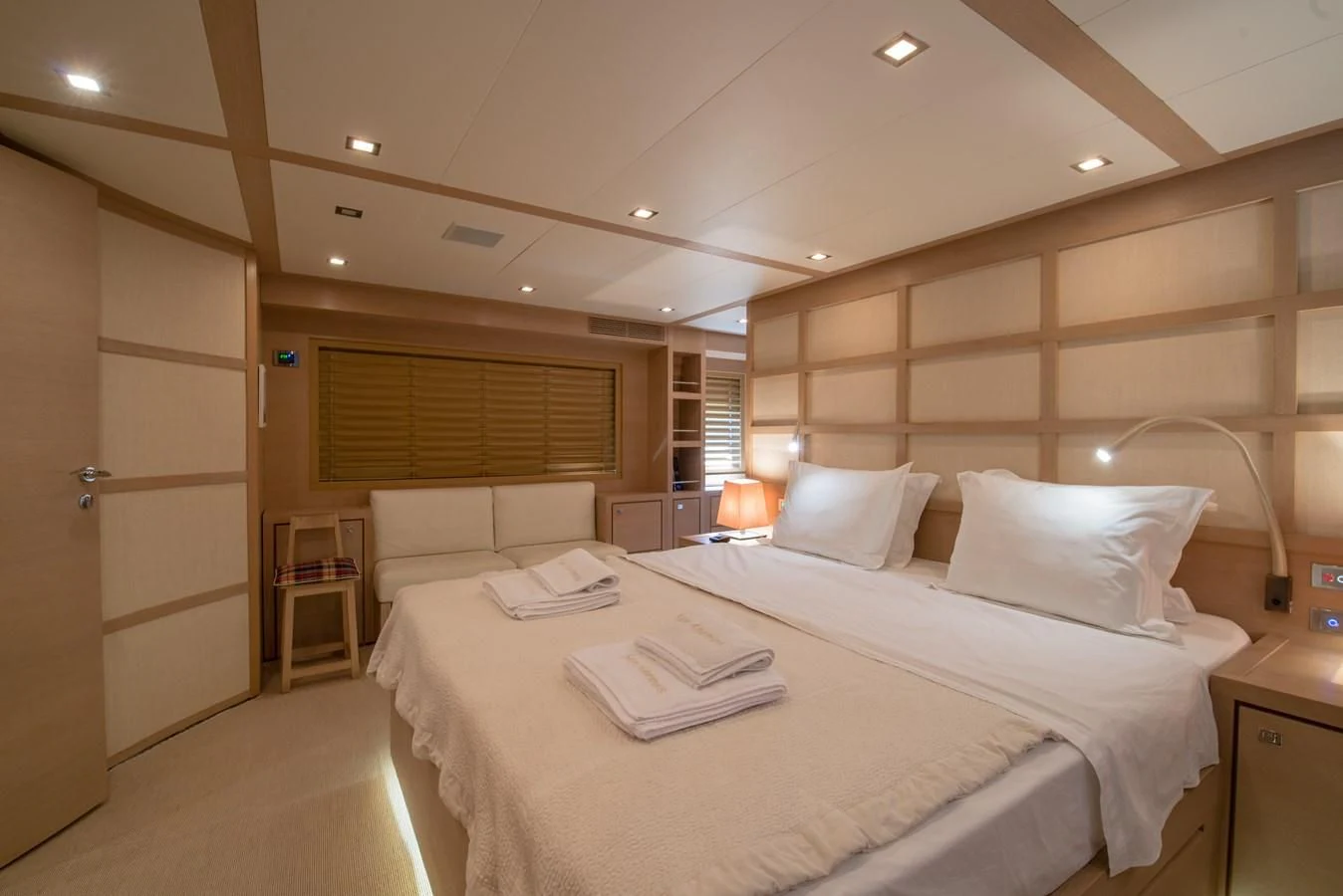 a room with a bed and a desk aboard SUN ANEMOS Yacht for Charter