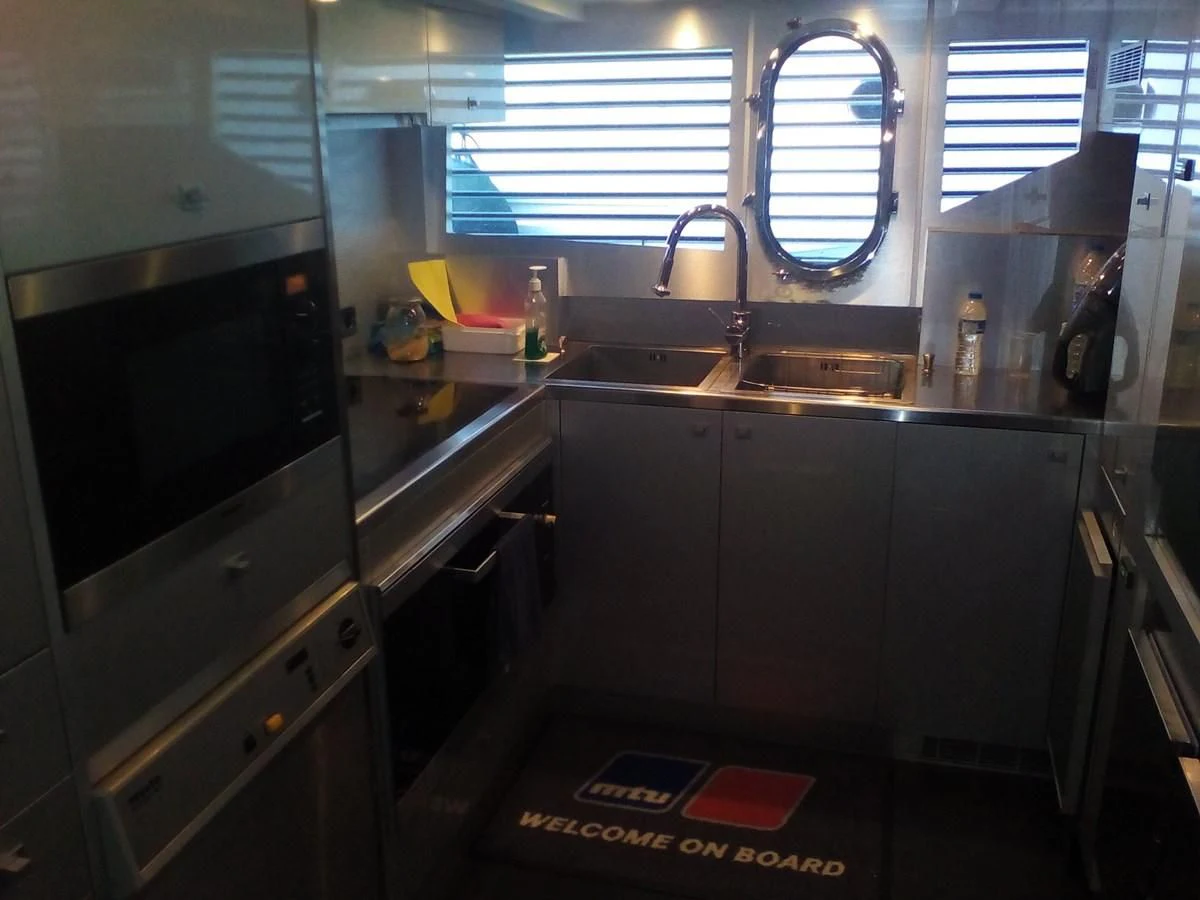 a kitchen with a sink and a window aboard SUN ANEMOS Yacht for Charter