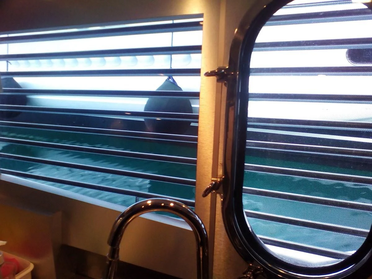 a window with blinds aboard SUN ANEMOS Yacht for Charter