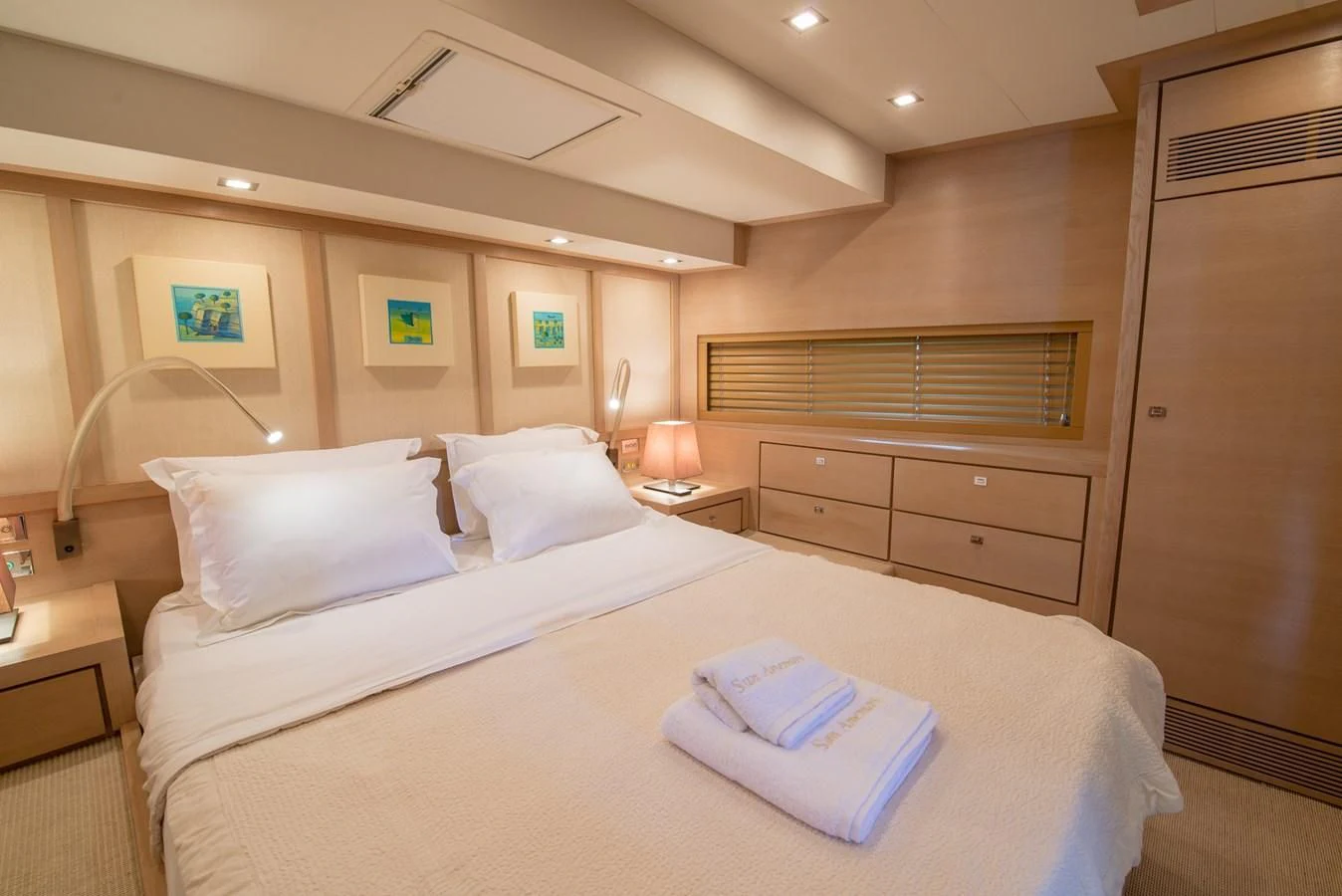 a bed with a white sheet and pillows on it aboard SUN ANEMOS Yacht for Charter