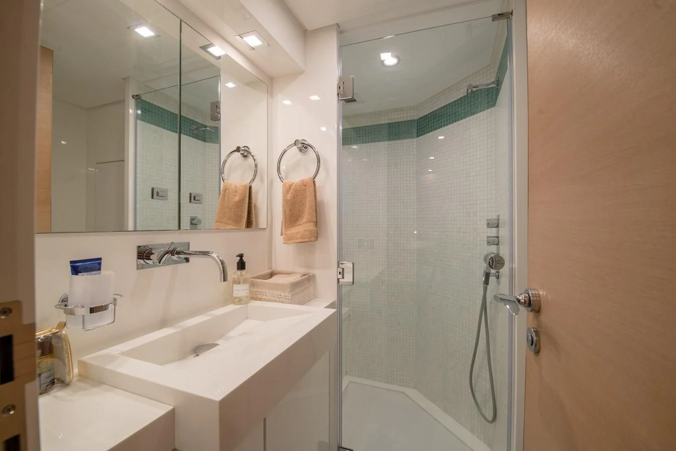 a bathroom with a glass shower door aboard SUN ANEMOS Yacht for Charter