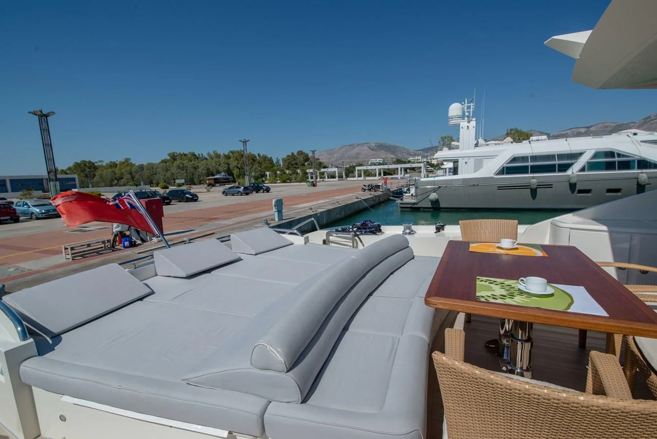 a couple of boats sit in a harbor aboard SUN ANEMOS Yacht for Charter
