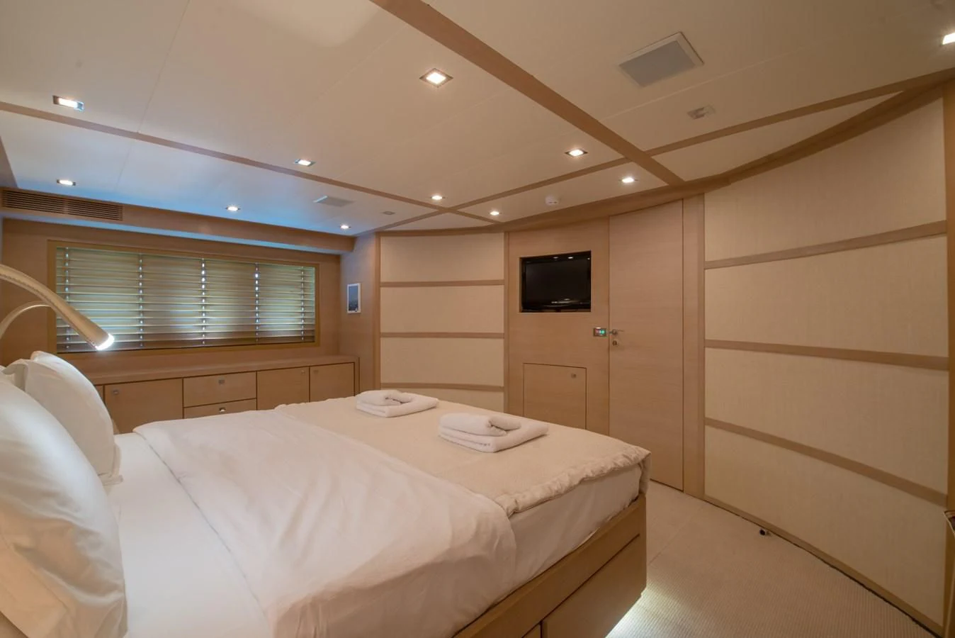 a room with a bed and a television aboard SUN ANEMOS Yacht for Charter