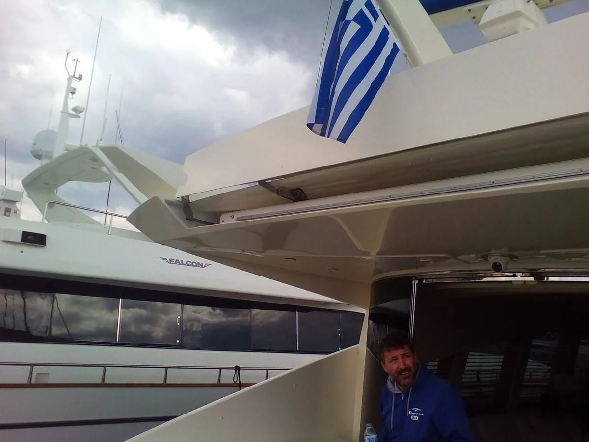 a man standing next to a plane aboard SUN ANEMOS Yacht for Charter