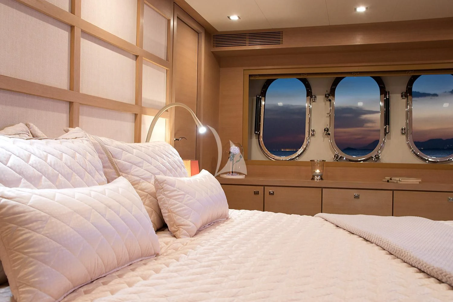 a bed with a large mirror above it aboard SUN ANEMOS Yacht for Charter