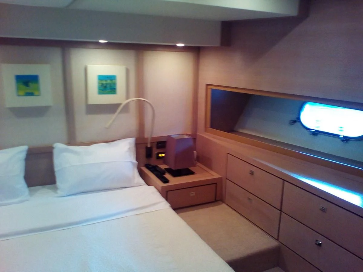 a room with a bed and a television aboard SUN ANEMOS Yacht for Charter