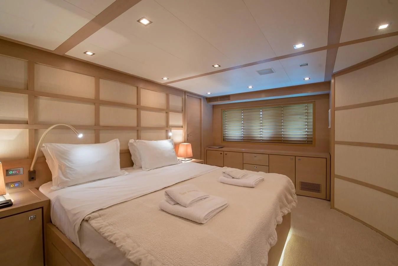 a room with a bed and a desk aboard SUN ANEMOS Yacht for Charter