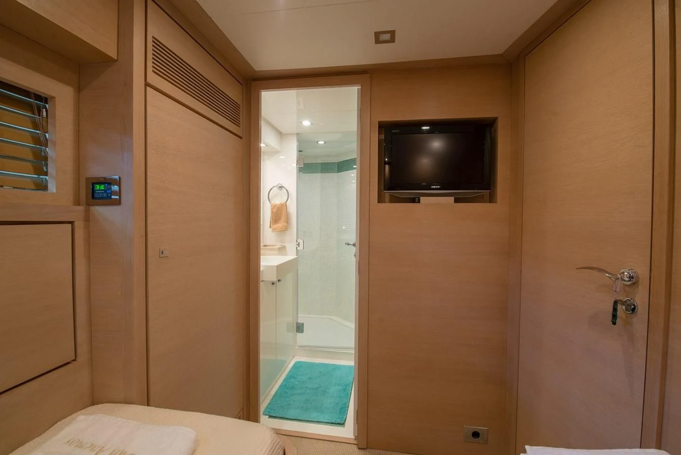 a bathroom with a tv and a shower aboard SUN ANEMOS Yacht for Charter