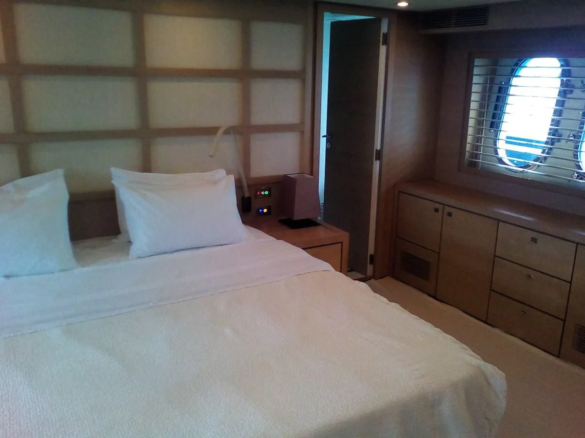 a bed with white sheets aboard SUN ANEMOS Yacht for Charter