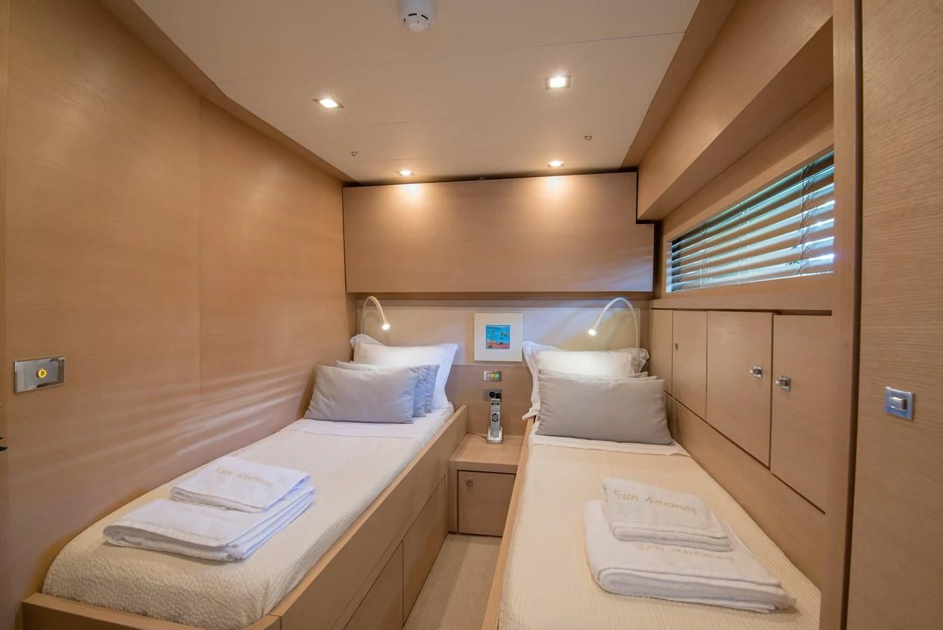 a room with a bed and a desk aboard SUN ANEMOS Yacht for Charter