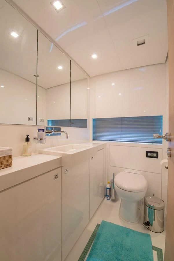 a bathroom with a toilet sink and a mirror aboard SUN ANEMOS Yacht for Charter