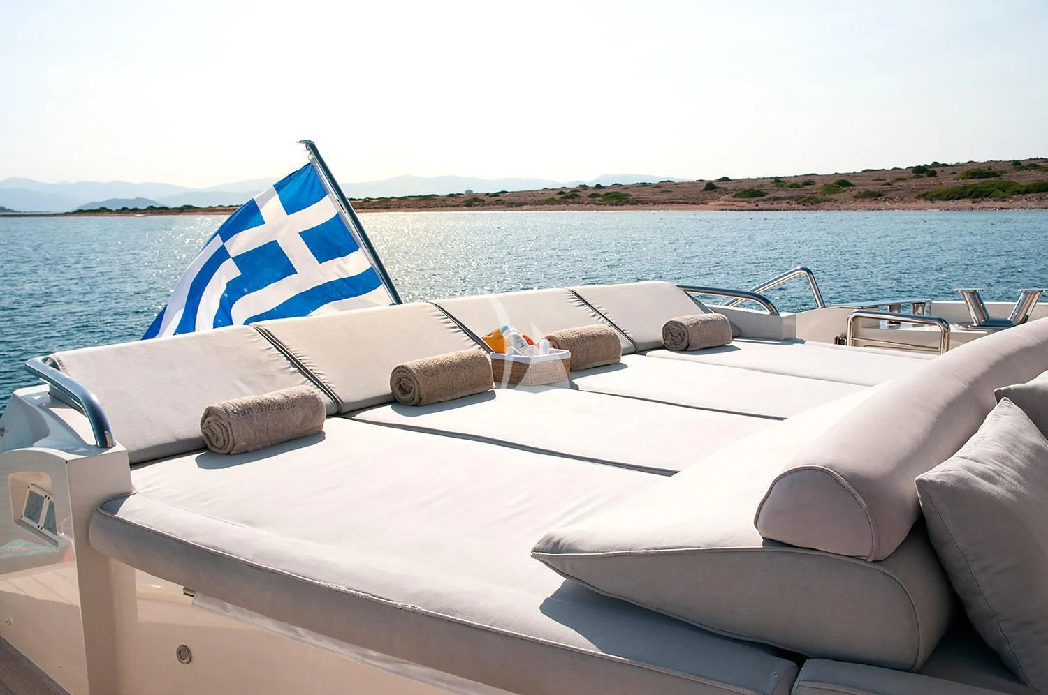 a boat with a flag on the front aboard SUN ANEMOS Yacht for Charter