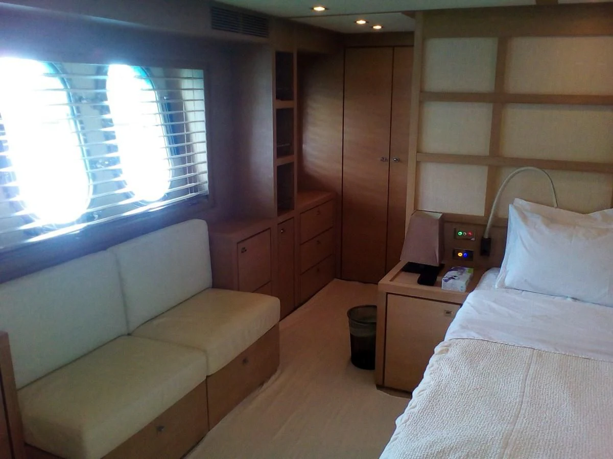 a room with a bed and a couch aboard SUN ANEMOS Yacht for Charter