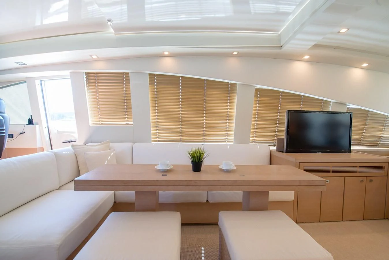 a room with a tv and couches aboard SUN ANEMOS Yacht for Charter
