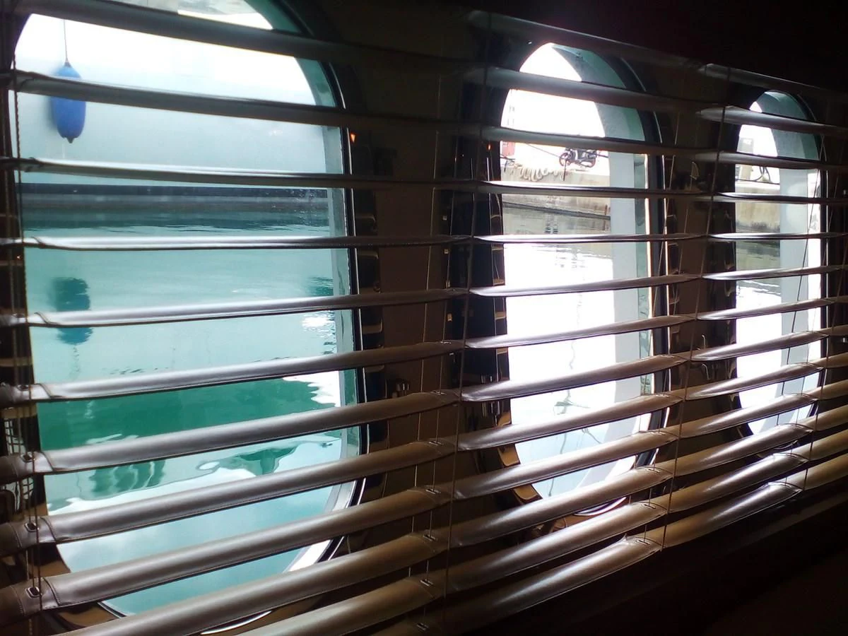a window with blinds aboard SUN ANEMOS Yacht for Charter