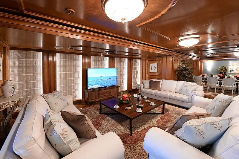 a living room with a large screen aboard LADY SARYA Yacht for Sale
