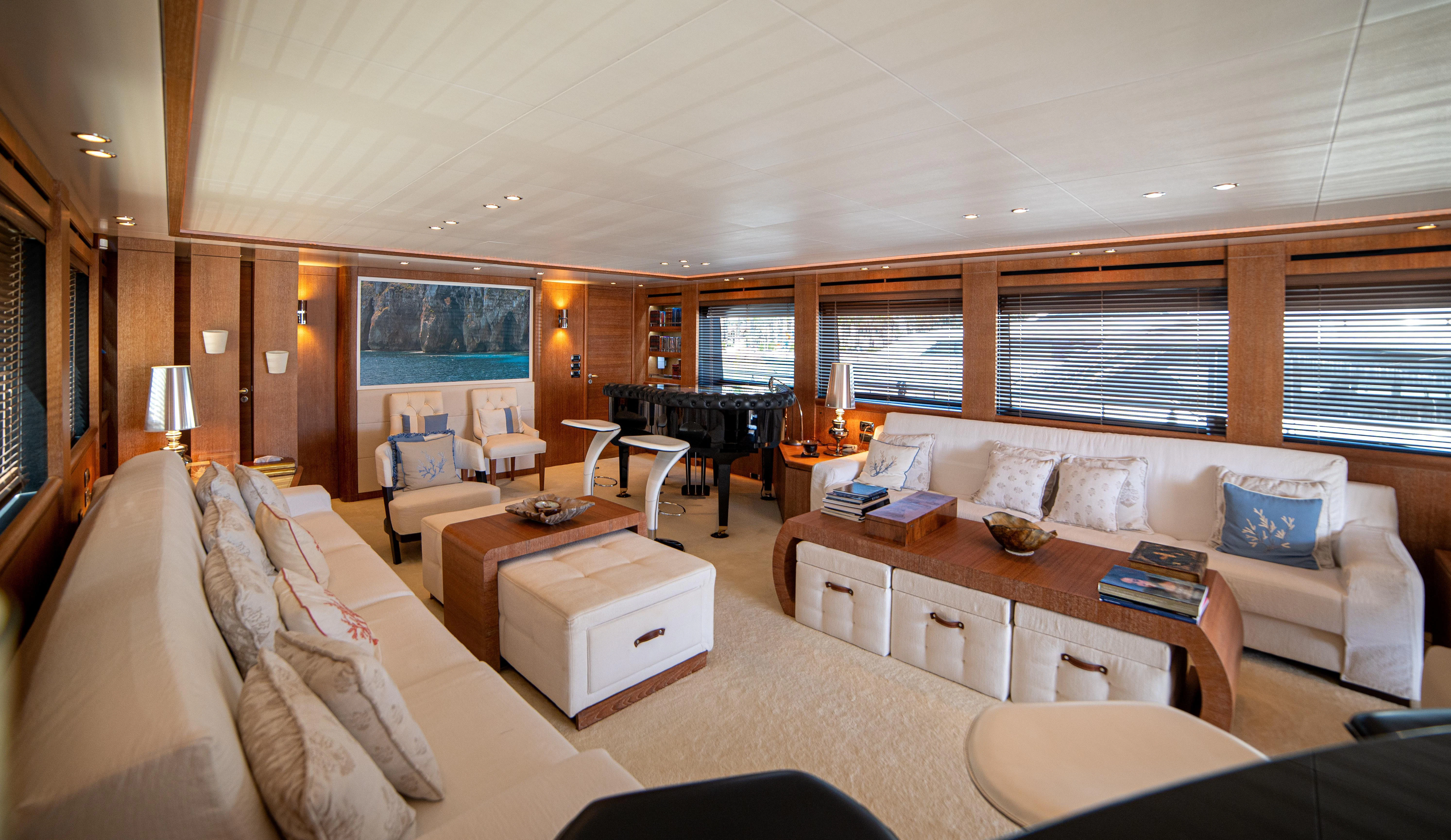 a living room with a piano and a piano aboard LADY SARYA Yacht for Sale