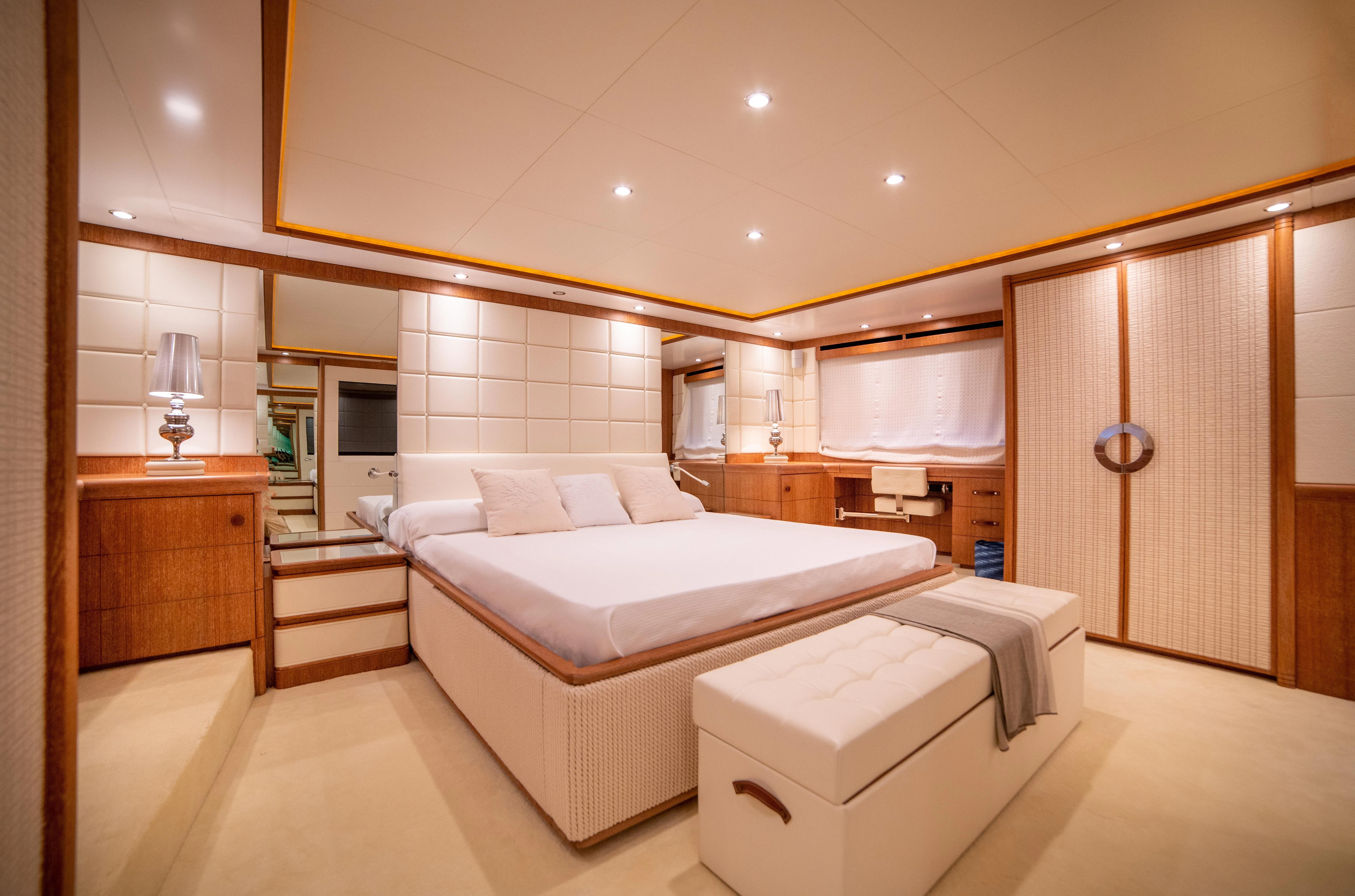 a large room with a bed and a mirror aboard LADY SARYA Yacht for Sale