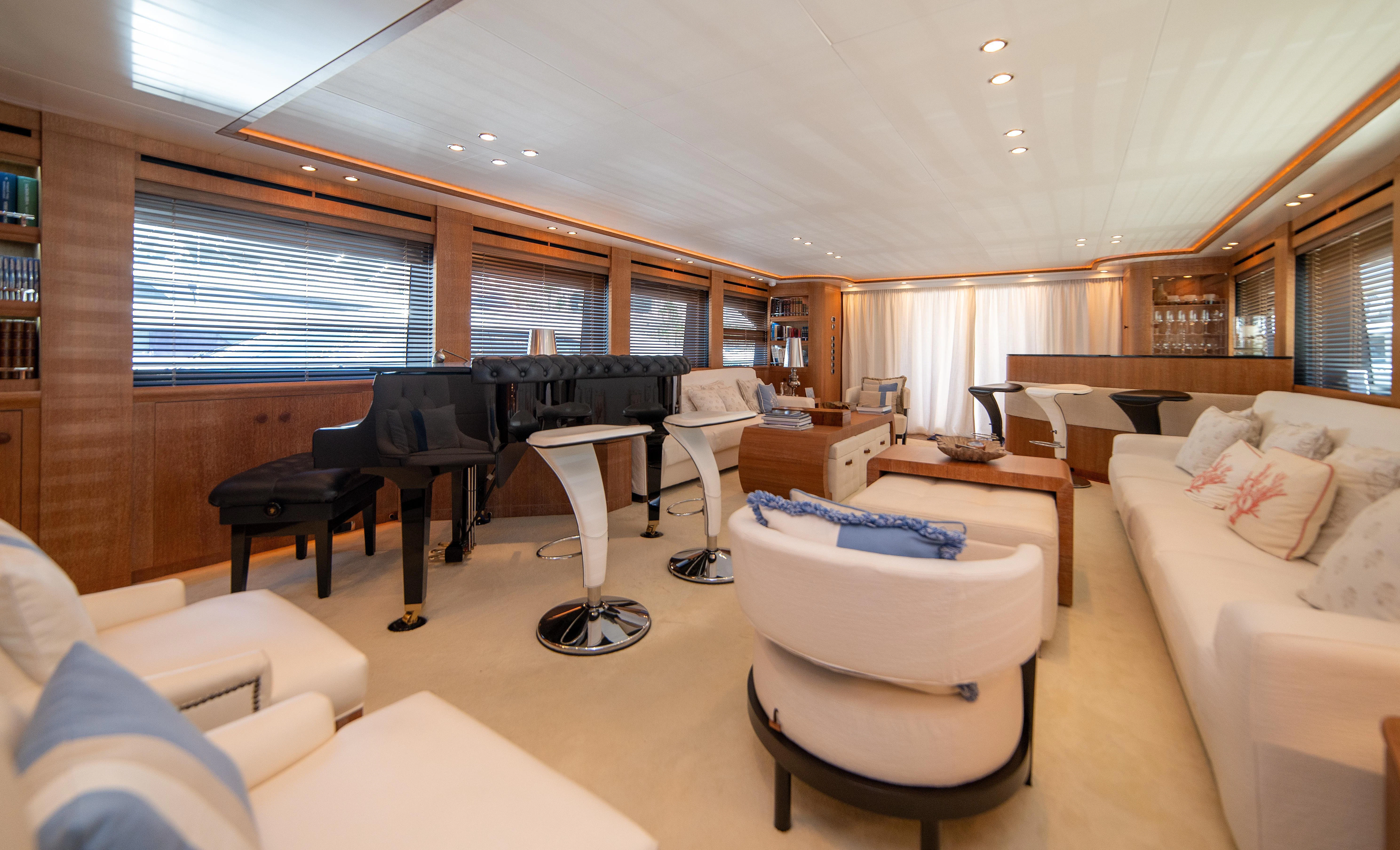 a living room with a piano and a couch aboard LADY SARYA Yacht for Sale