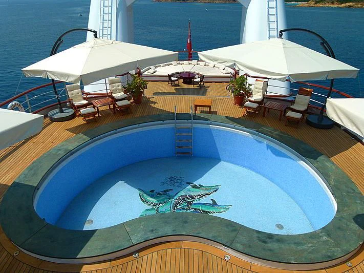 a swimming pool with chairs and umbrellas aboard LADY SARYA Yacht for Sale