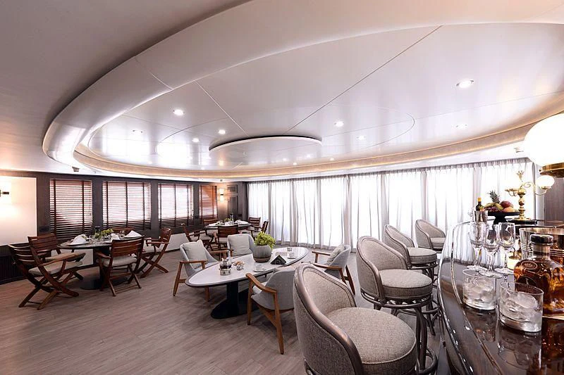 a room with tables and chairs aboard LADY SARYA Yacht for Sale