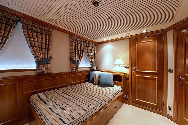a bedroom with a bed and a closet aboard LADY SARYA Yacht for Sale