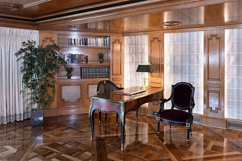 a room with a table chairs and plants aboard LADY SARYA Yacht for Sale