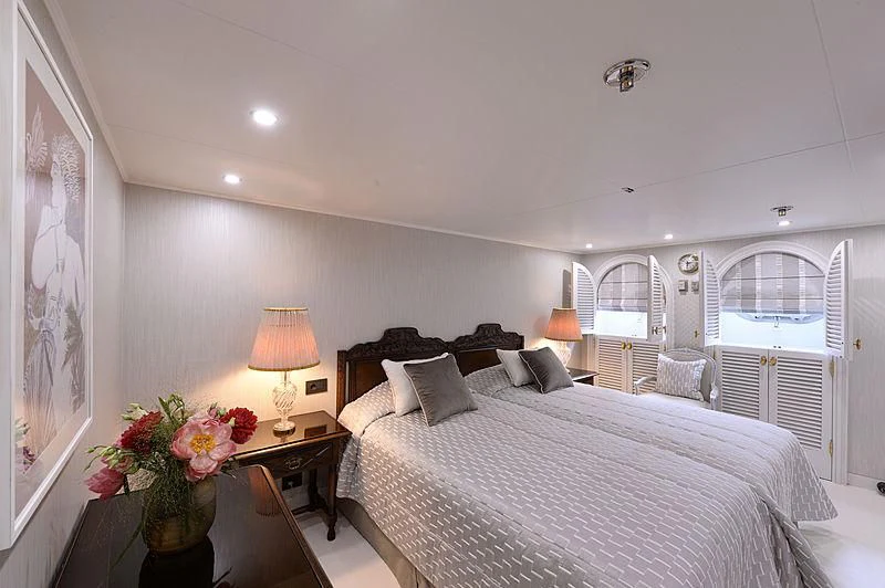 a bedroom with a large bed aboard LADY SARYA Yacht for Sale