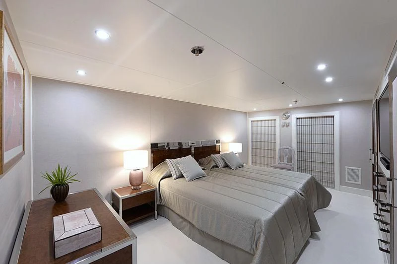 a bedroom with a bed and a table aboard LADY SARYA Yacht for Sale