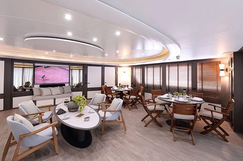 a large room with tables and chairs aboard LADY SARYA Yacht for Sale