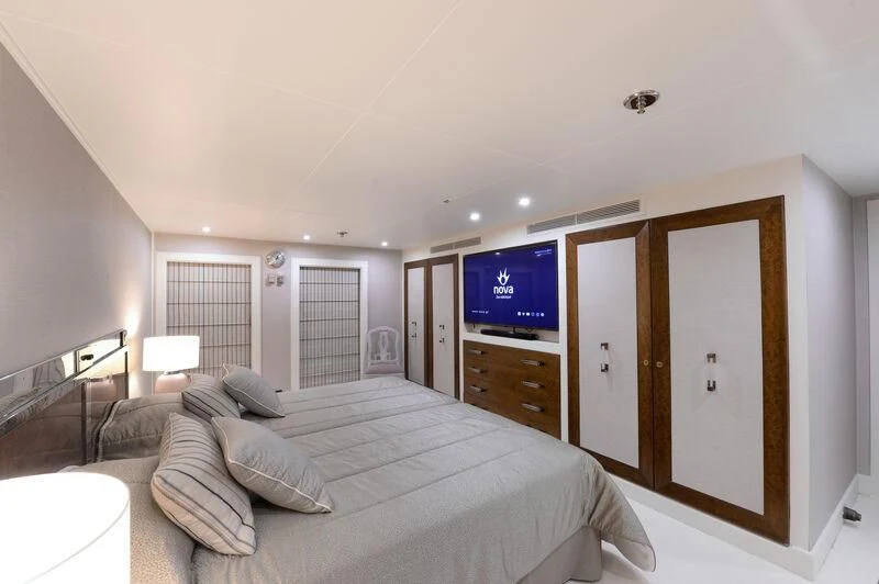 a bedroom with a bed and a tv on the wall aboard LADY SARYA Yacht for Sale