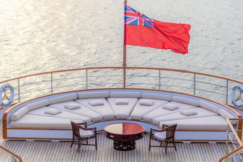a pool table with chairs and a flag on it aboard LADY SARYA Yacht for Sale
