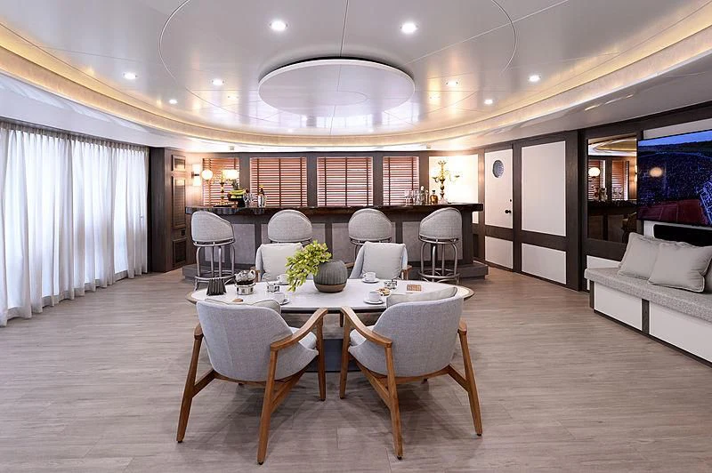 a large room with a table and chairs aboard LADY SARYA Yacht for Sale