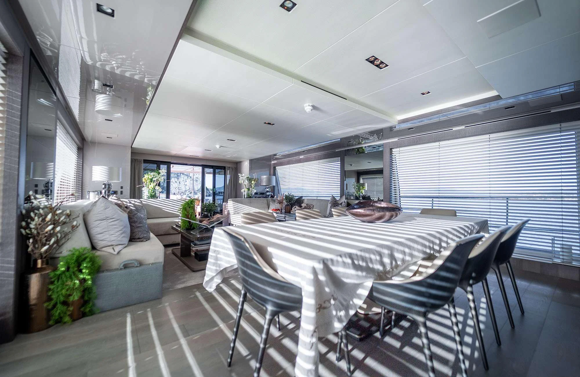 a large dining room with a large white table and chairs aboard THE PALM Yacht for Sale