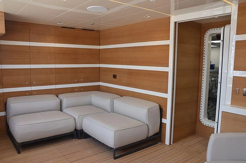 a room with couches and a mirror aboard THE PALM Yacht for Sale