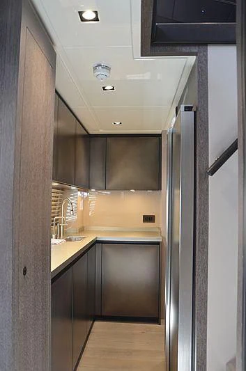 a kitchen with a large refrigerator aboard THE PALM Yacht for Sale