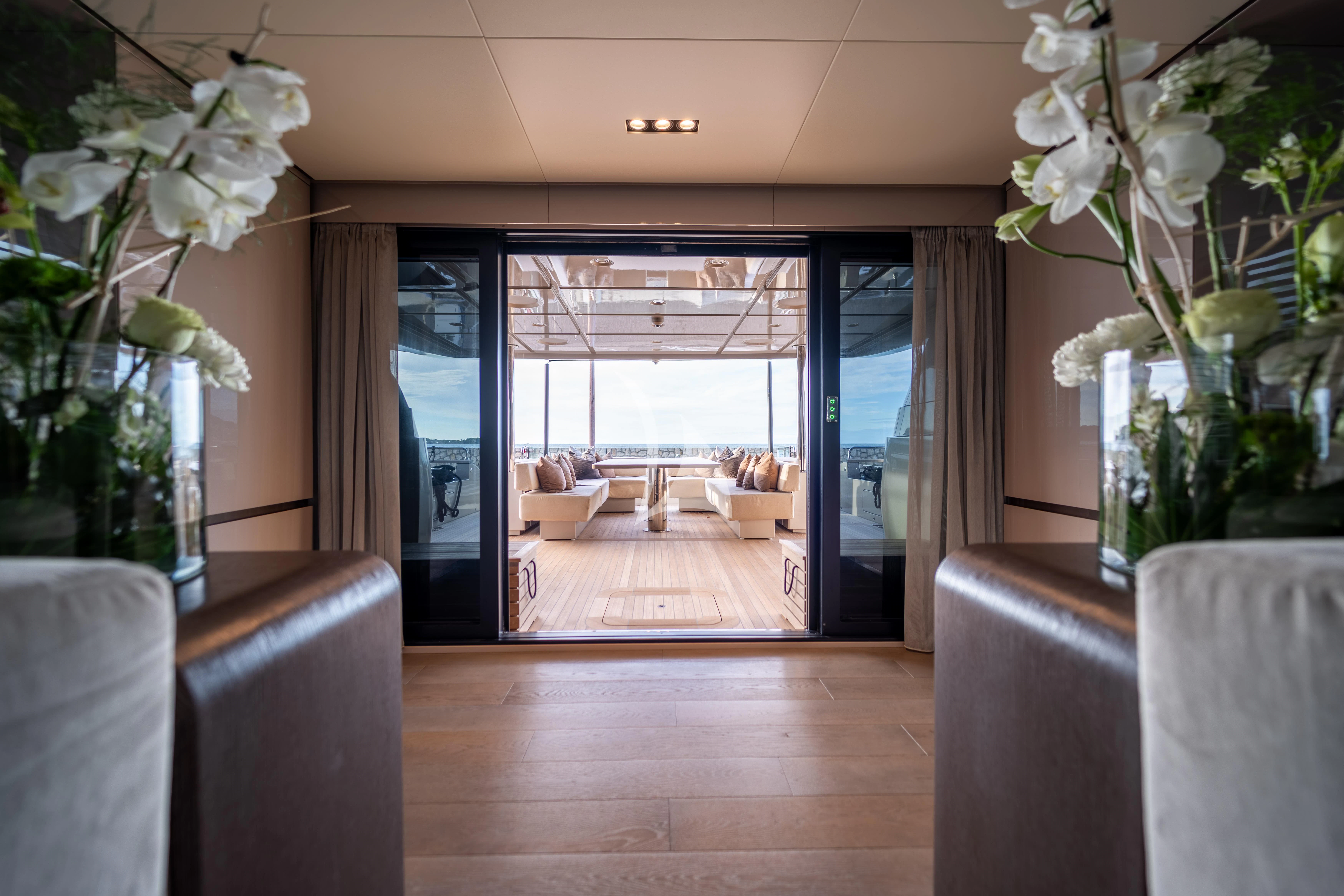 a room with a table chairs and a plant in it aboard THE PALM Yacht for Sale