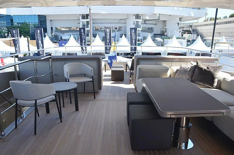a room with a couch and a table with chairs aboard THE PALM Yacht for Sale