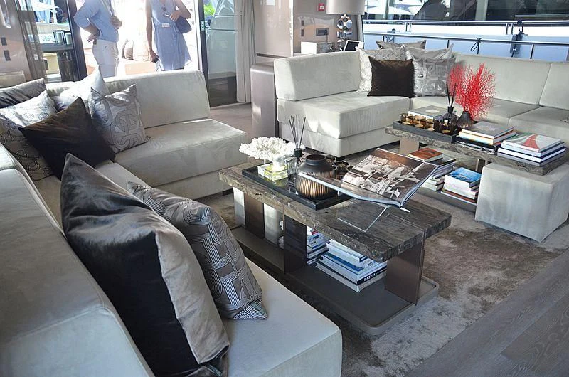a living room with a couch and coffee table aboard THE PALM Yacht for Sale