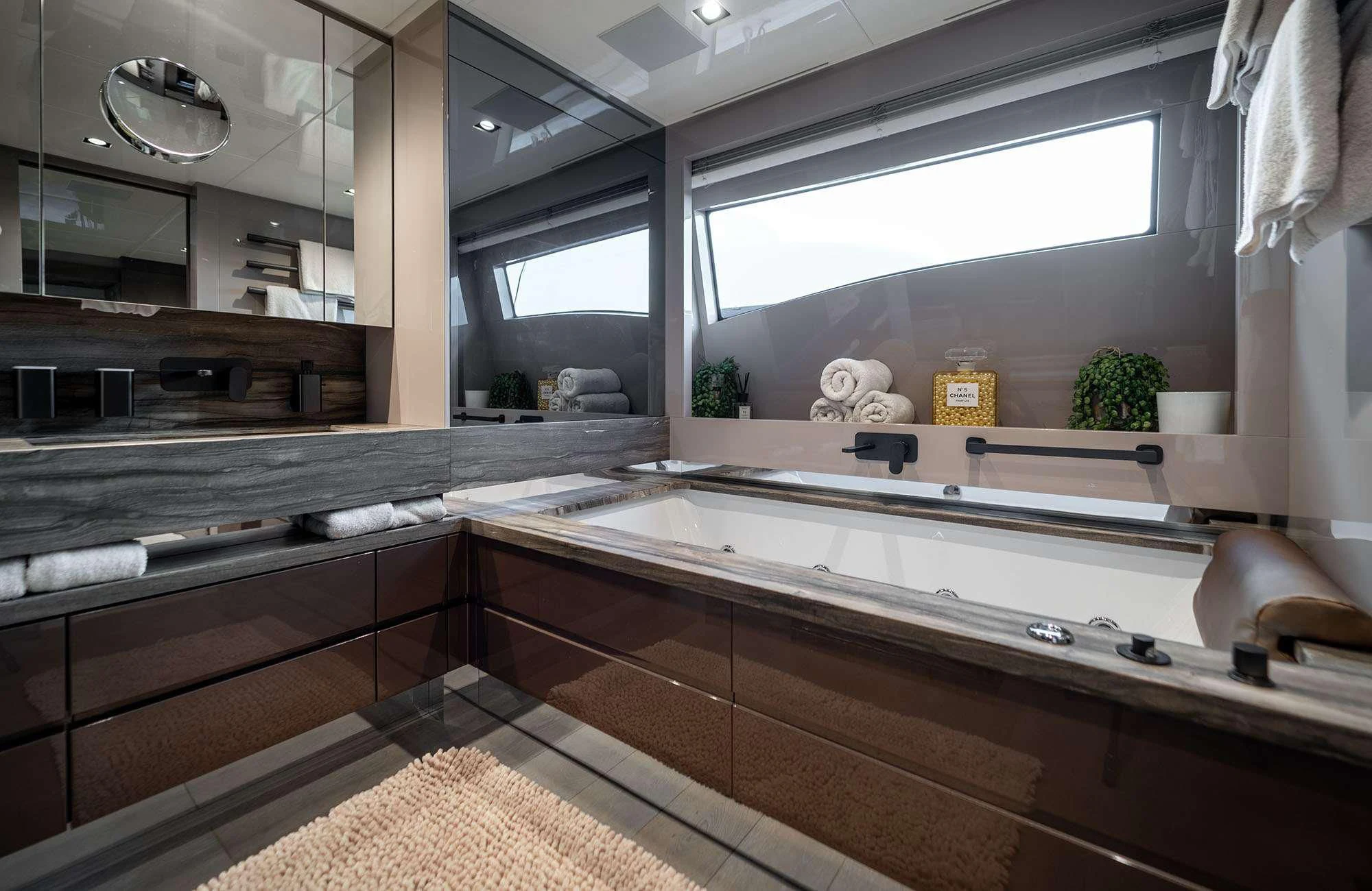 a bathroom with a large window aboard THE PALM Yacht for Sale