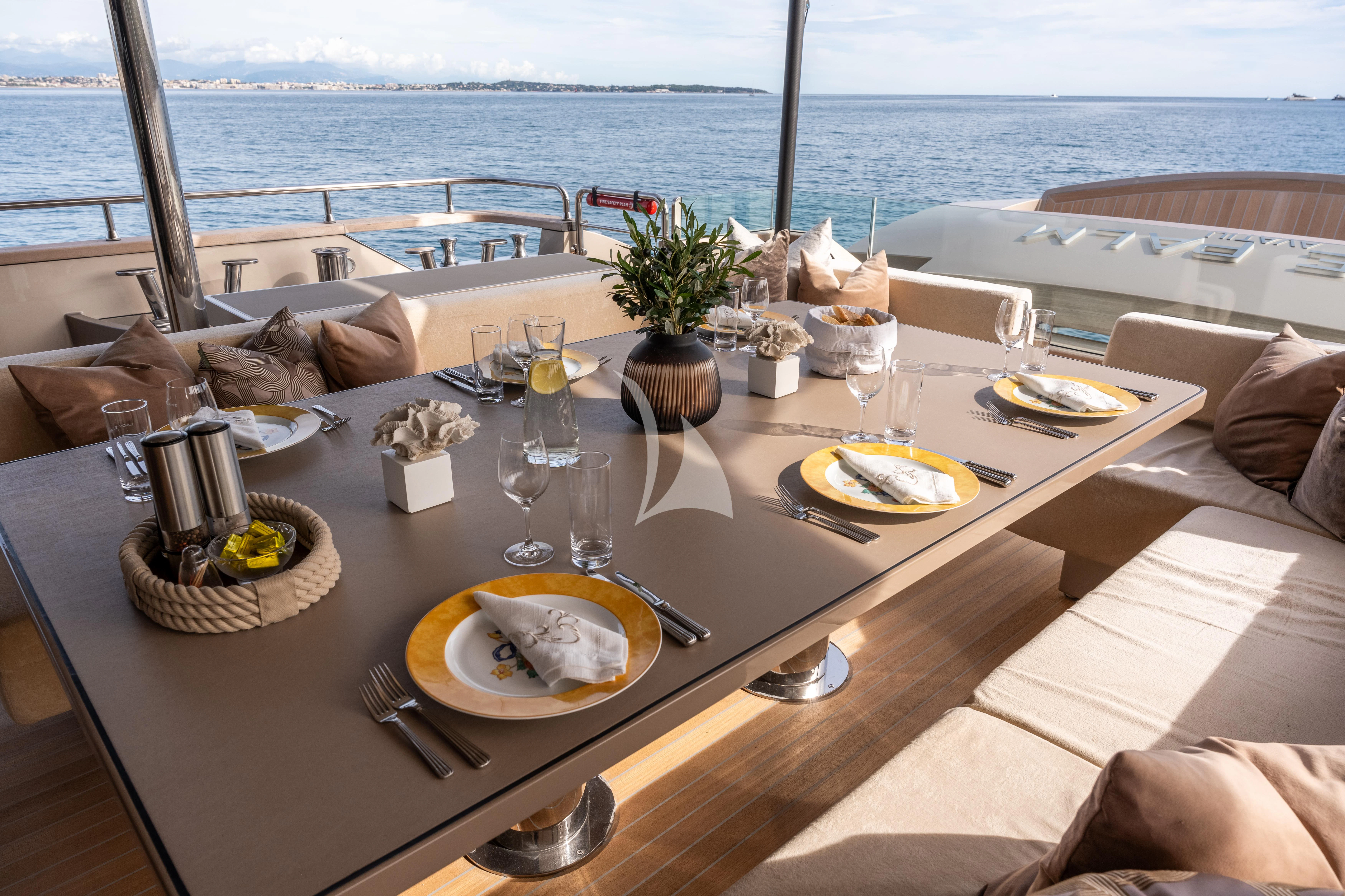 a table with plates and food on it aboard THE PALM Yacht for Sale