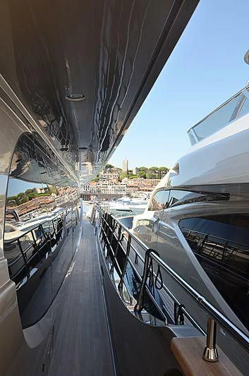 a boat is parked on the side of a dock aboard THE PALM Yacht for Sale