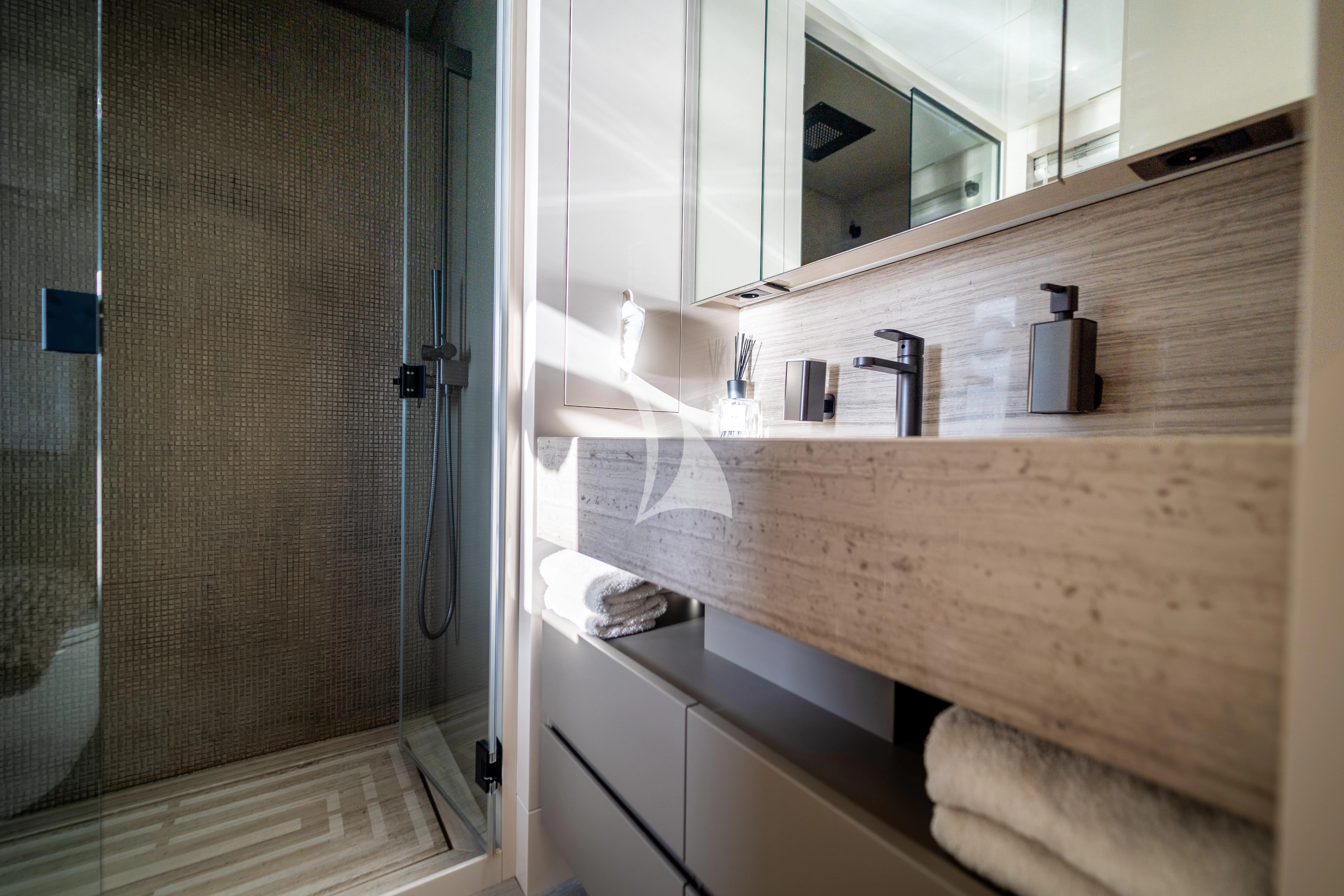 a bathroom with a countertop sink and mirror aboard THE PALM Yacht for Sale