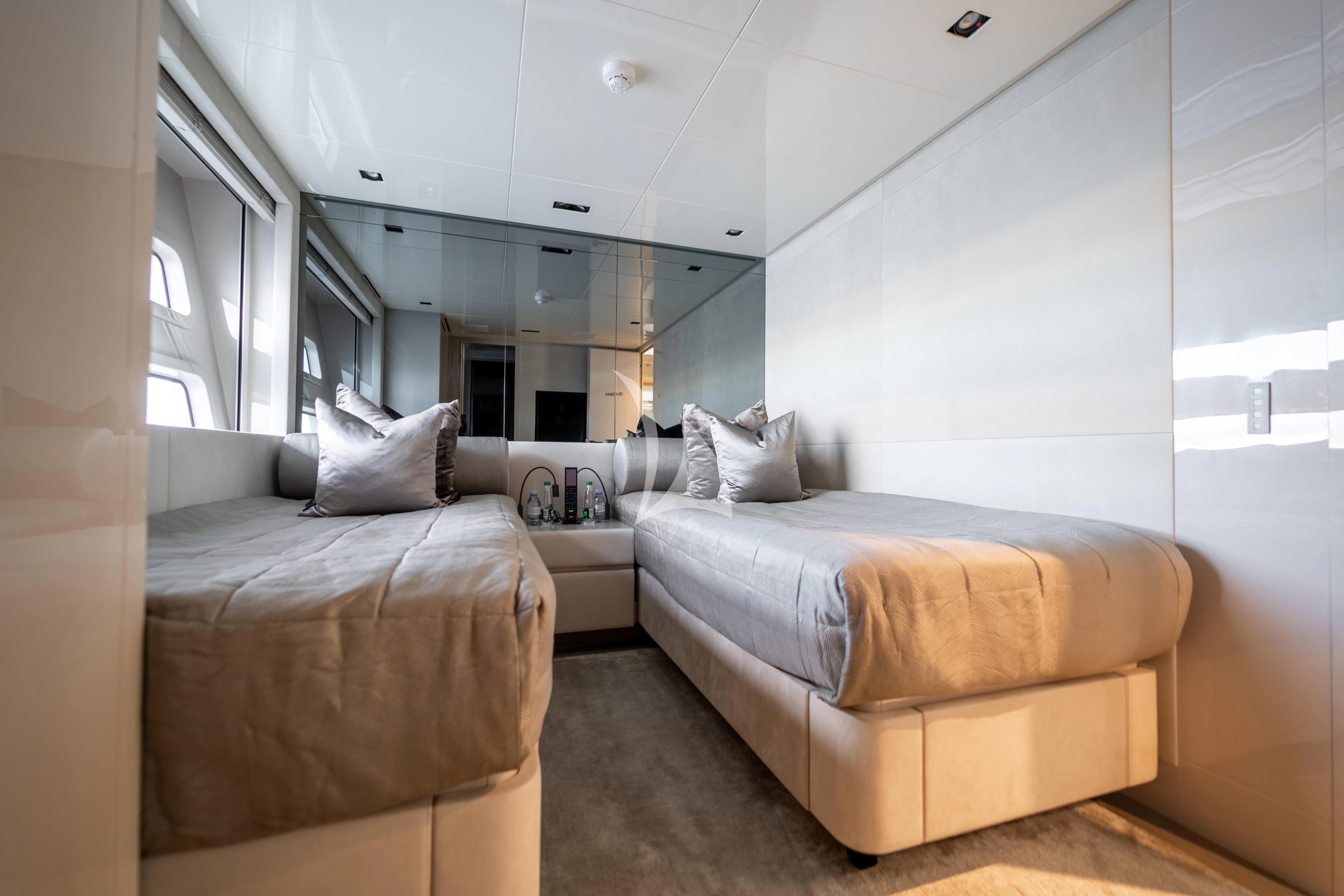 a room with two beds aboard THE PALM Yacht for Sale