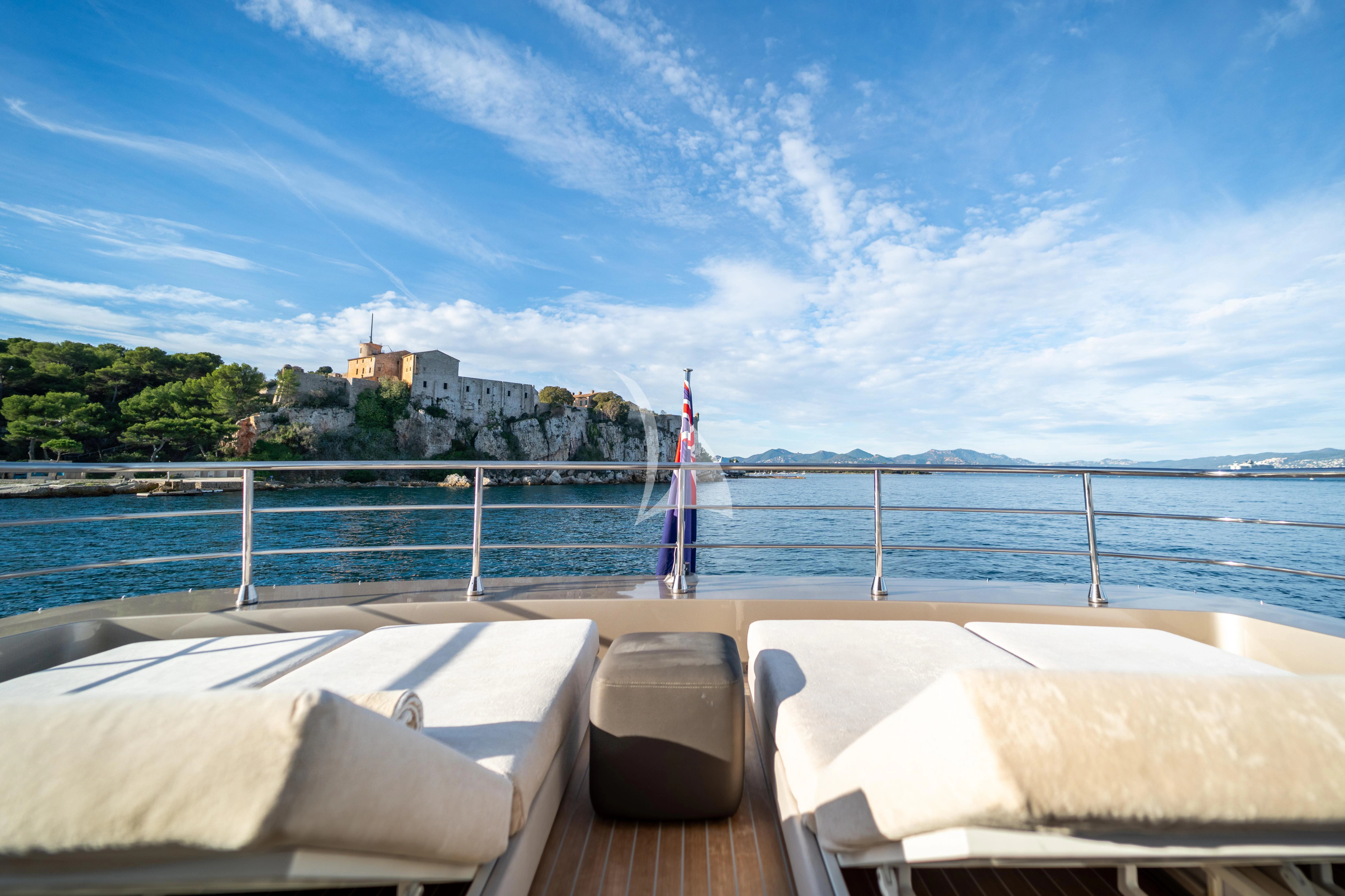 a deck with a beach and a flag on it aboard THE PALM Yacht for Sale