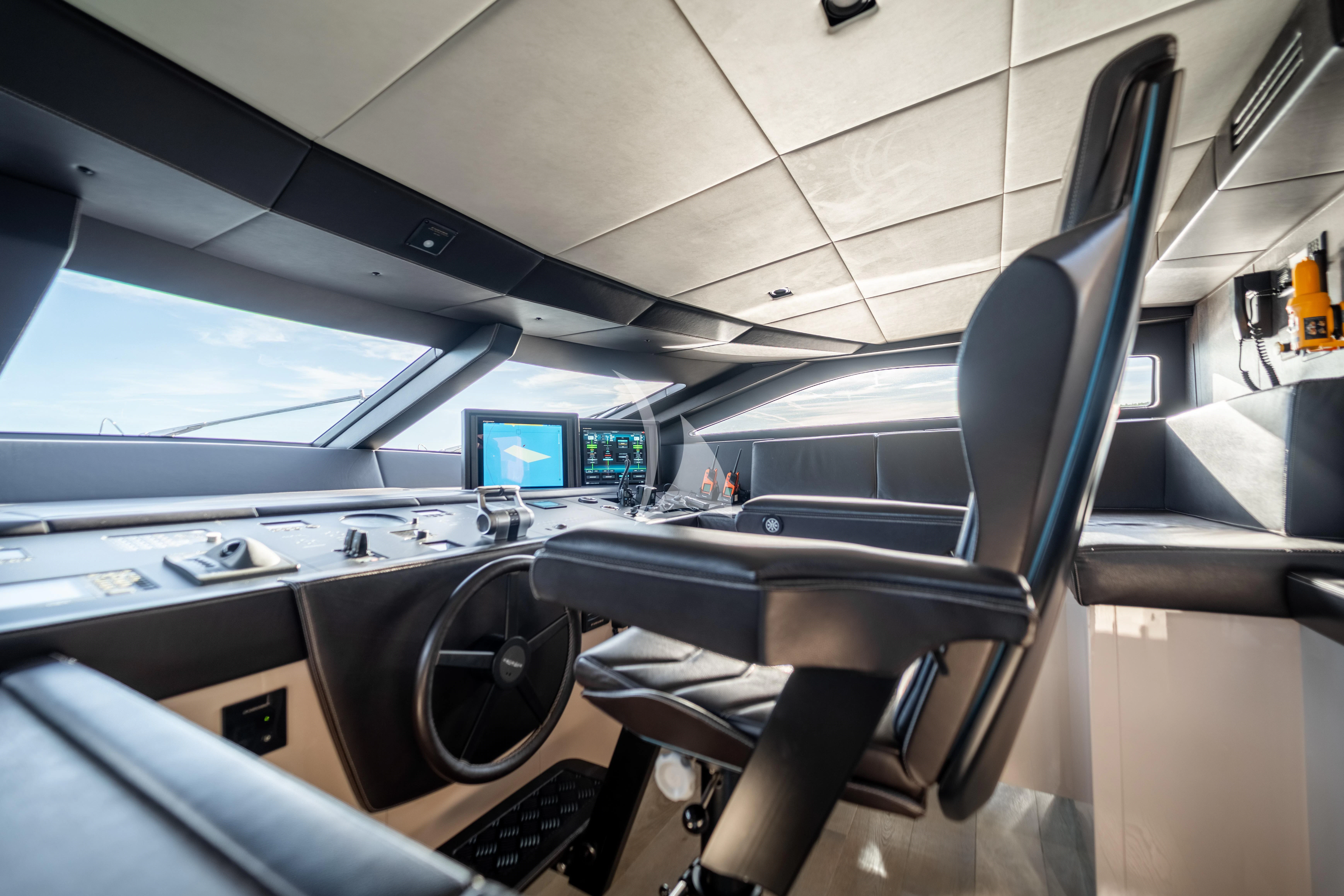 inside of a vehicle with a screen and a computer on the wall aboard THE PALM Yacht for Sale