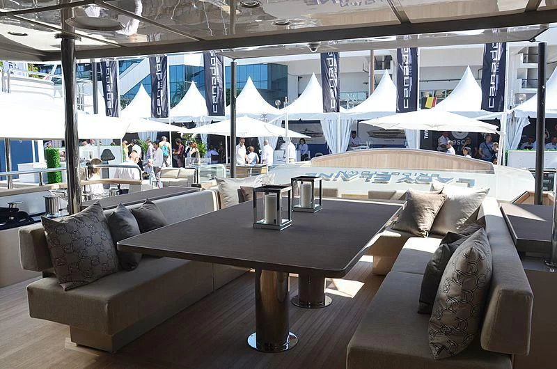 a room with a table and couches aboard THE PALM Yacht for Sale