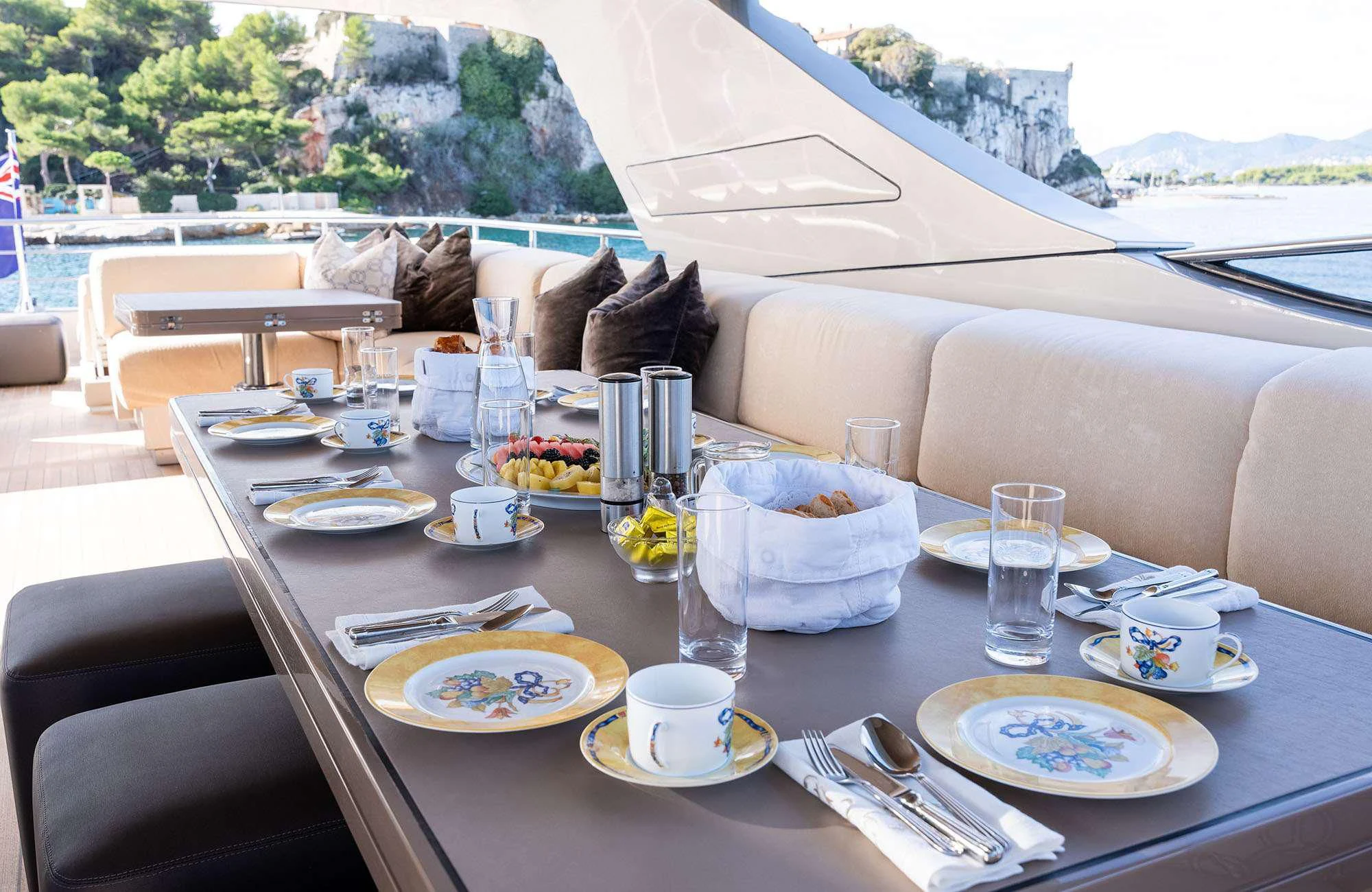 a table with plates and glasses on it aboard THE PALM Yacht for Sale