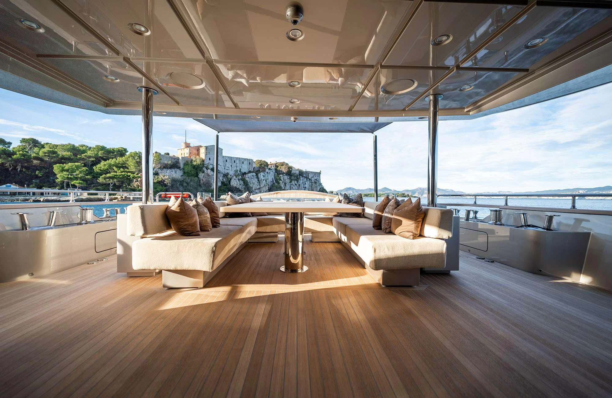 a room with a table and couches aboard THE PALM Yacht for Sale