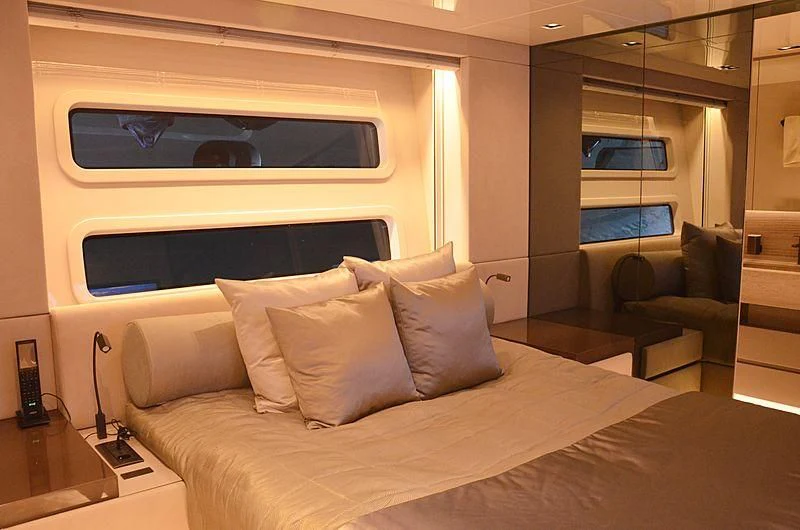 a bed with a white pillow aboard THE PALM Yacht for Sale